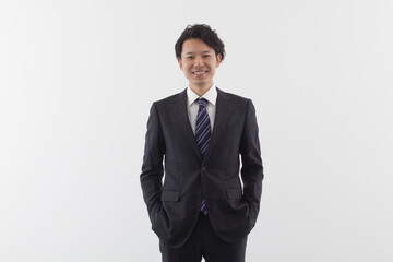 A young Asian business man standing with smile