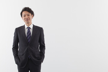 A young Asian business man standing with smile