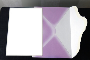 postcard and pink envelope on a dark background for mockup, selective focus