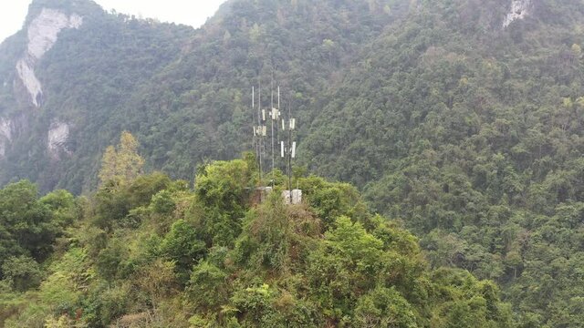 Communication base stations and antennas on a mountain top in karst terrain