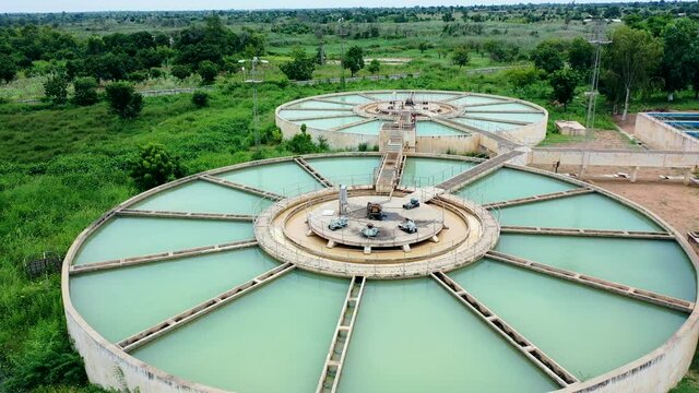 Green tanks filled with water at the Ajiwa dam in the Katsina State in Nigeria - panning aerial view