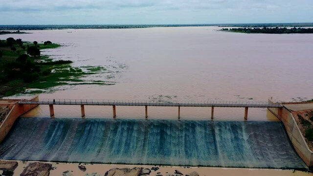 Overflow water runs off the Ajiwa Dam in Nigeria's Katsina State - pull back aerial view