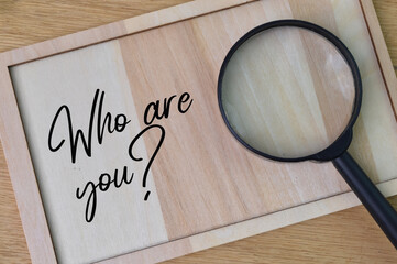 Wooden board written with question WHO ARE YOU?