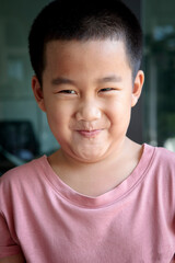 headshot funny face of asian children at home living room