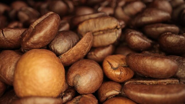 Flight over freshly roasted Coffee Beans - sliding macro shot