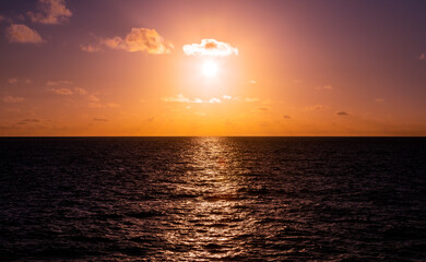 Beautiful golden sunset and clouds over the  Pacific Ocean viewed from an ocean liner.