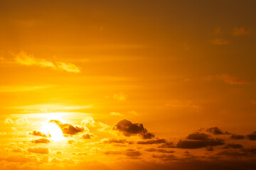 Landscape view of stunning golden sunset over a calm ocean, with nature's silhouette gently contrasting against the vibrant sky.