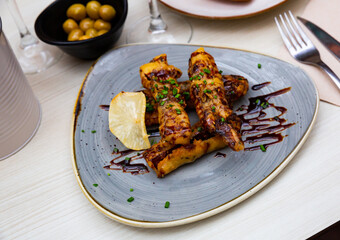 Delicious Spanish dish with grilled eggplant, cane sugar and green onions