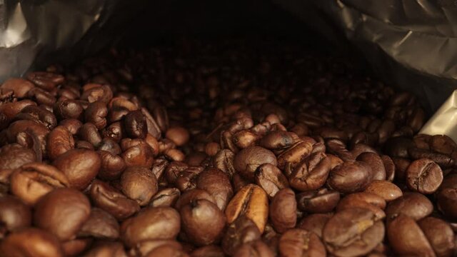 Flight over freshly roasted Coffee Beans - sliding macro shot