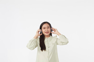 Joyful beautiful young Asian girl in headphones