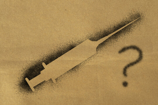 Covid. Lack of vaccine and cure. Doubt, question. Concept design, figure printed on its outlines with spray paint. Paper texture.