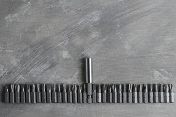 Screwdriver bits for various slots laid out in a row
