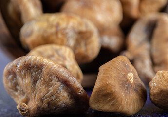 Bowl of dried figs on blue background