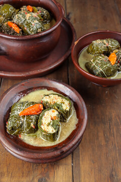 Buntil daun singkong is traditional indonesian food made from cassava leaves Stuffed with grated coconut, petai cina, and anchovy fish. Served on traditional plate
