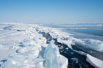 Fototapeta na wymiar Big crack on the ice on Lake Baikal in winter. Russia Siberia.