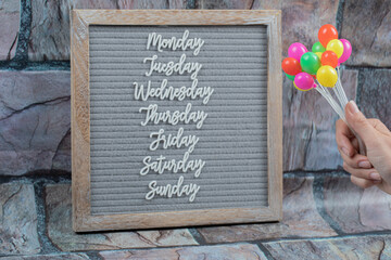 Happy weekdays poster written with letter symbols on the grey tissue