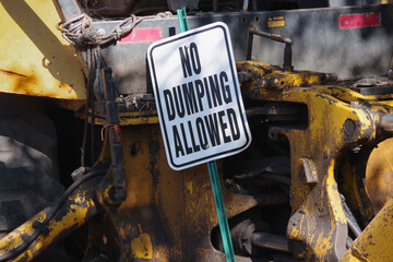 Sign at a temporarily abandoned construction site NO DUMPING ALLOWED