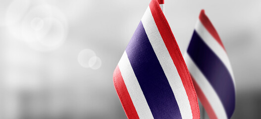 Small national flags of the Thailand on a light blurry background