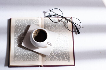 cup of coffee with book and glasses