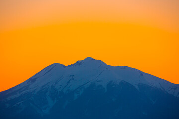 オレンジに染まる雪の岩木山