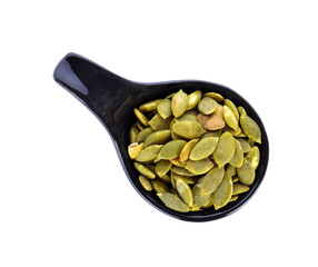pumpkin seed in black spoon on white background