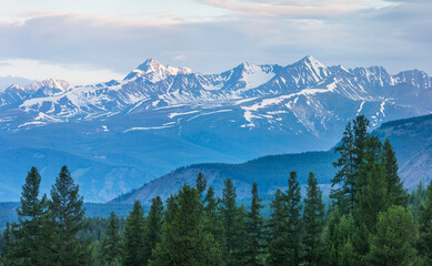 Snow capped mountain peaks in morning light, summer travel	
