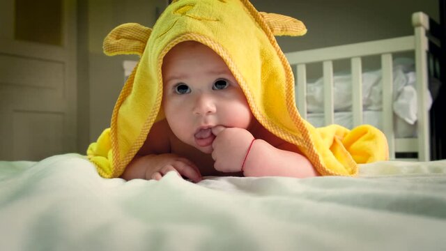 Baby after bathing in a towel. Selective focus.