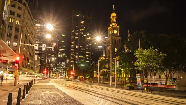 night traffic in the city with trams passing by and traffic lights blinking in a time lapse video