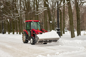 Snow removal in winter in the park with mechanical means