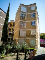 Building in a popular residential area, next to a small park
