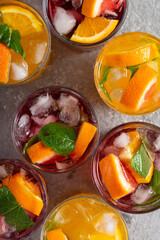 Summer cocktails and drinks with fruits and ice, top view