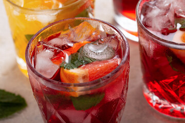 Close up of sangria in glasses with ice and fresh fruits, close up
