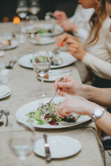 hands close up with etiquette cutlery. Eating a fish dish close up. Table etiquette.