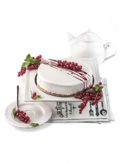 homemade mousse cake side view covered with mirror glaze, decorated with red currant berries and fruit syrup on white background isolated closeup. Selective focus