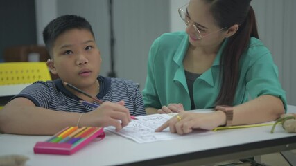 Education concept of 4k Resolution. The teacher is teaching disabled children to draw and paint.