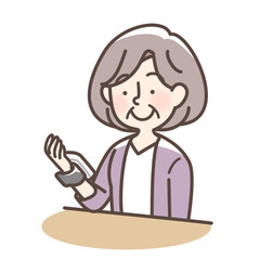血圧をはかるおばあさん　手首式測定機