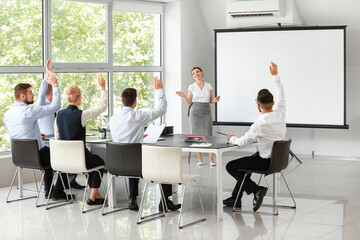 Businesswoman giving presentation during meeting in office