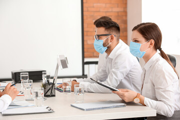 Business people having meeting in office during coronavirus epidemic