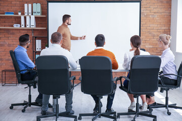 Businessman giving presentation during meeting in office