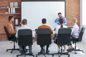Businessman giving presentation during meeting in office