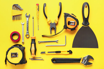 Set of construction tools on color background