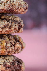 Chocolate crocante cookies with nuts on a pink background