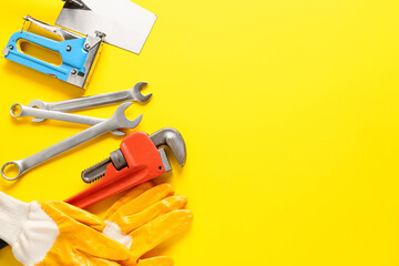 Set of construction tools on color background