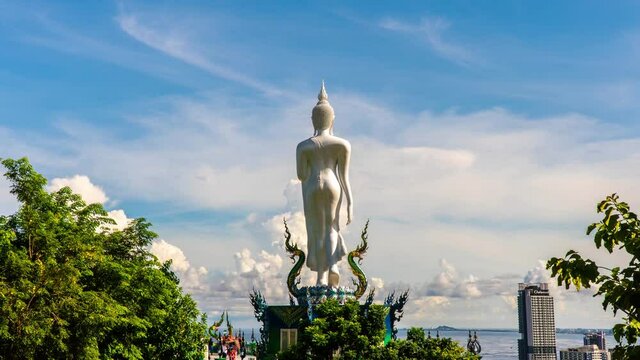 Time Lapse Clouds blue sky and Buddha statue in Wat khao phra kru temple located in Sriracha city Chonburi, Thailand. Important places to travel when visiting Thailand 