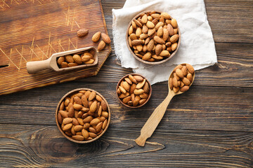 Composition with tasty almonds on wooden background