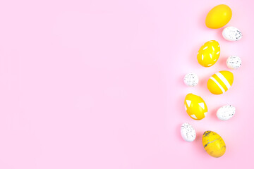 Happy easter concept. Eggs are yellow on a pink pastel background. Flat lay, top view, copy space.