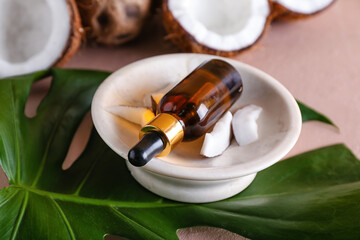 Composition with bottle of coconut oil on color background