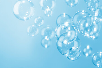 Beautiful shiny transparent blue soap bubbles background.