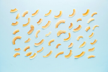 Tasty coconut chips on color background