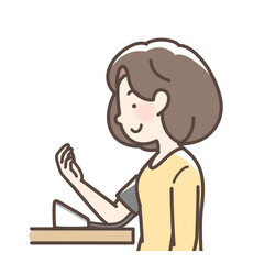 血圧を測定する女性　上腕式測定機